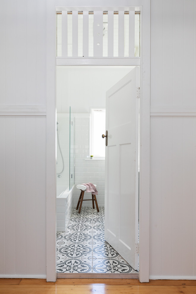 Inspiration for a traditional kids bathroom in Brisbane with a drop-in tub, a shower/bathtub combo, white tile and white walls.