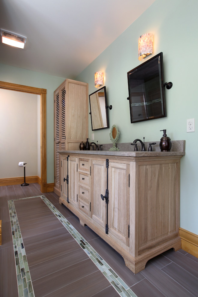 Mid-sized traditional master bathroom in Grand Rapids with raised-panel cabinets, light wood cabinets, a freestanding tub, an alcove shower, beige tile, green walls, an undermount sink, porcelain floors and granite benchtops.