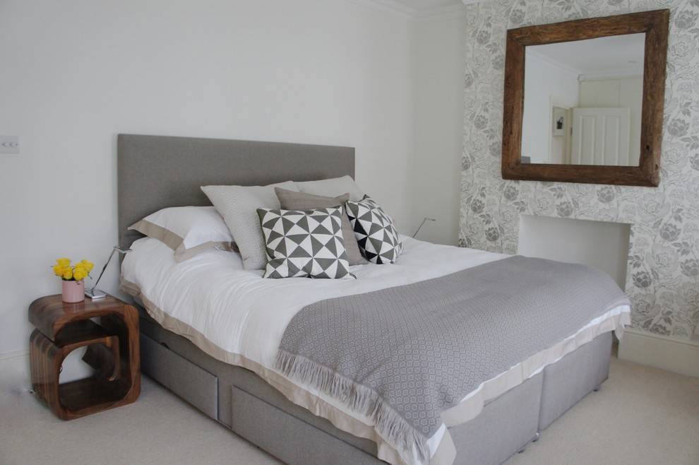 This is an example of a mid-sized eclectic master bedroom in London with white walls and carpet.