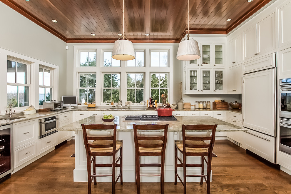 Photo of an expansive transitional u-shaped kitchen in Providence with shaker cabinets, white cabinets, stainless steel appliances and with island.