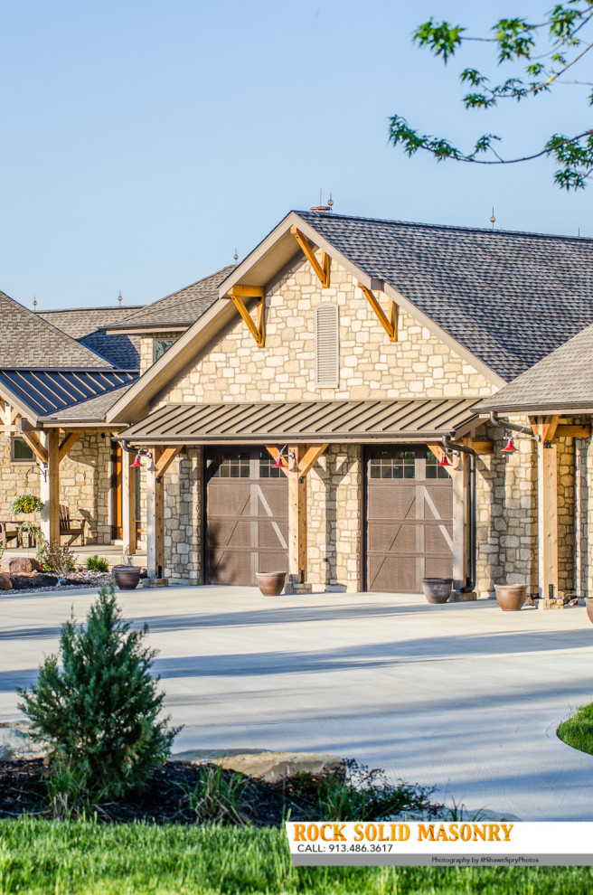 This is an example of a country beige house exterior in Kansas City with stone veneer.