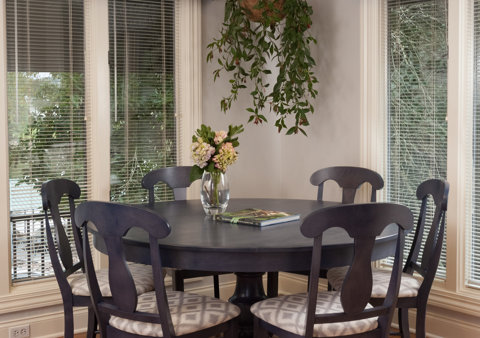 Example of a mid-sized transitional l-shaped medium tone wood floor and brown floor enclosed dining room design with an undermount sink, recessed-panel cabinets, white cabinets, quartz countertops, gray backsplash, stone tile backsplash, stainless steel appliances, an island and gray countertops