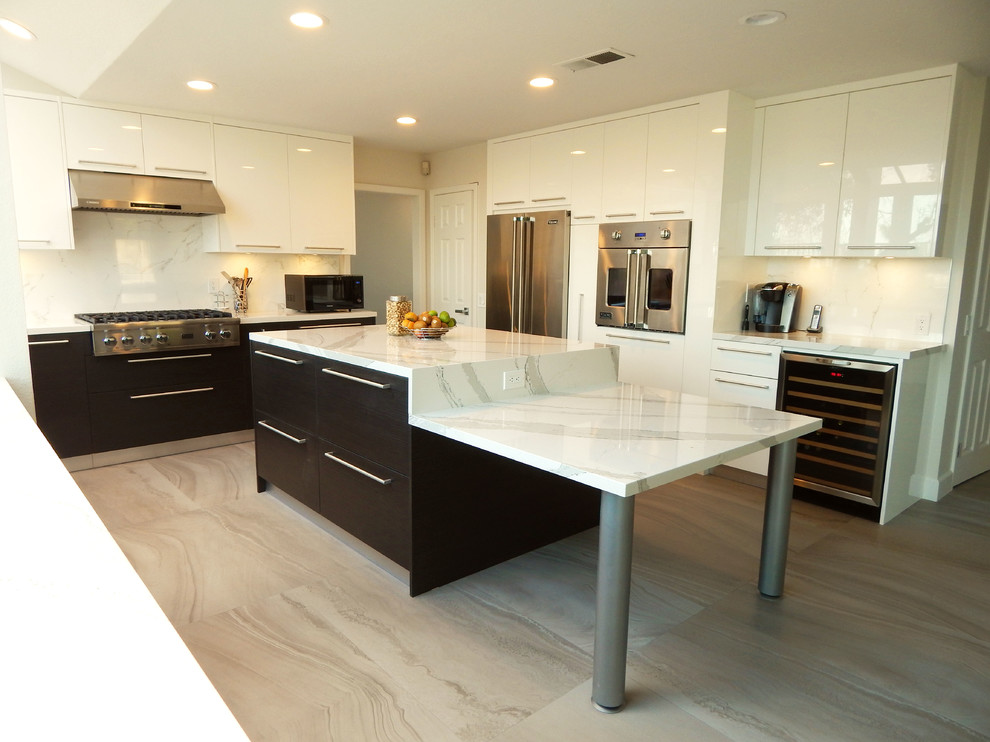 Design ideas for a large contemporary u-shaped eat-in kitchen in Los Angeles with flat-panel cabinets, white cabinets, quartz benchtops, white splashback, porcelain splashback, stainless steel appliances, porcelain floors and with island.