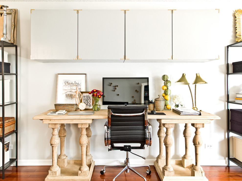 Photo of a transitional study room in Chicago with white walls, medium hardwood floors and a freestanding desk.