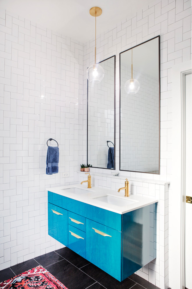 Design ideas for a mid-sized contemporary master bathroom in Chicago with furniture-like cabinets, blue cabinets, white tile, ceramic tile, white walls, ceramic floors, black floor, white benchtops, a freestanding tub, a corner shower, a wall-mount toilet, a drop-in sink, quartzite benchtops, a hinged shower door, a shower seat, a double vanity and a floating vanity.
