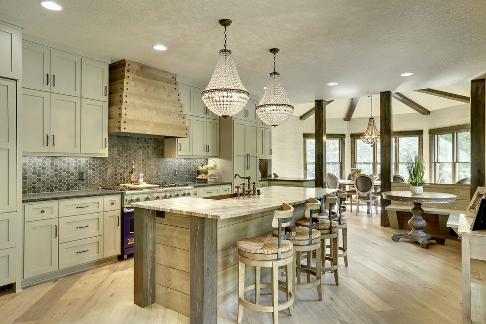 Photo of a country galley open plan kitchen in Minneapolis with a farmhouse sink, shaker cabinets, beige cabinets, grey splashback, panelled appliances and with island.