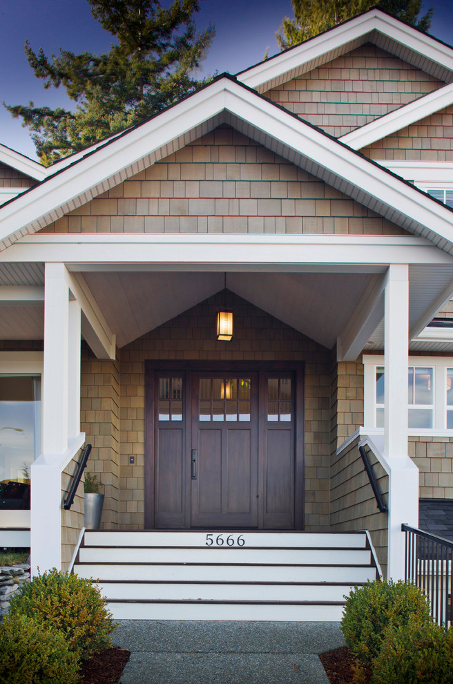Design ideas for a traditional front yard verandah in Vancouver with a roof extension.