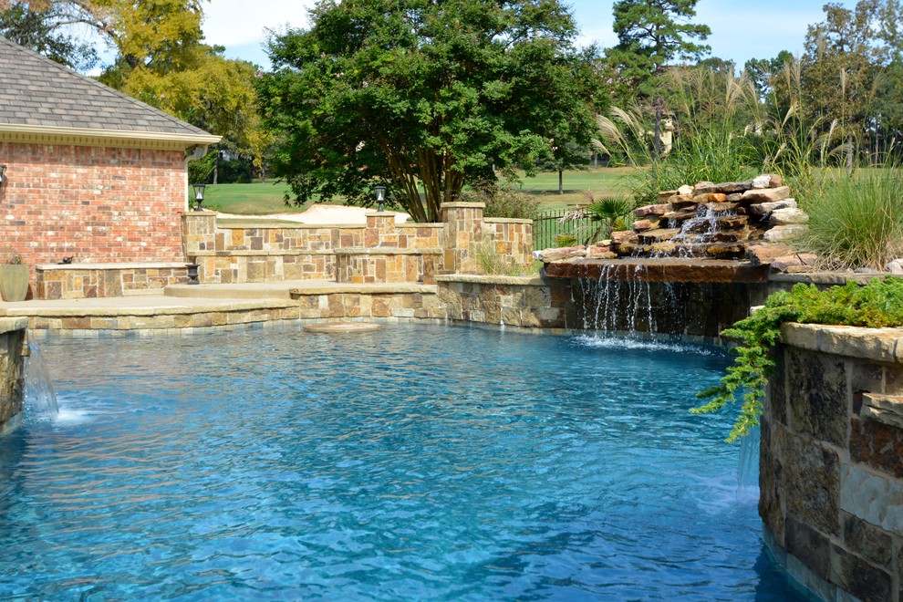 Inspiration for a large country backyard custom-shaped lap pool in Little Rock with a water feature and concrete slab.