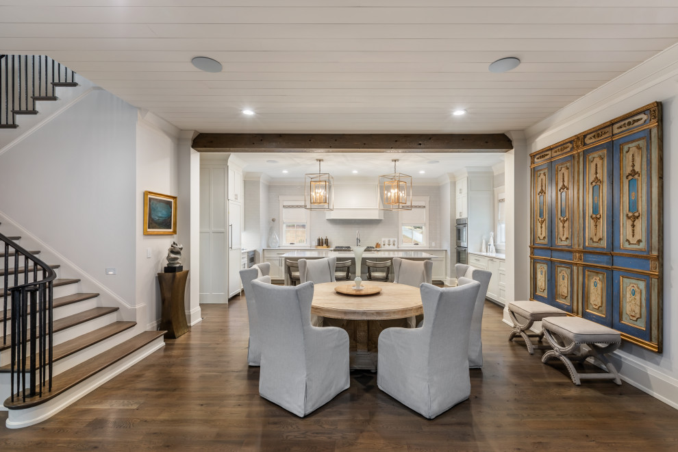 Large transitional kitchen/dining combo in Other with dark hardwood floors and timber.