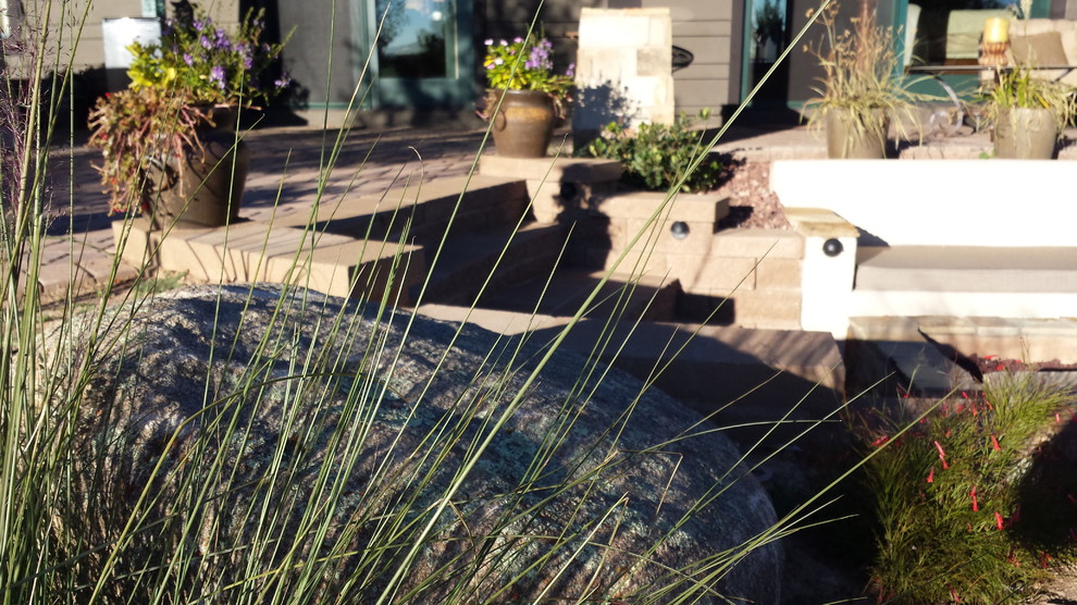 Photo of a mid-sized rustic drought-tolerant backyard mulch landscaping in Phoenix.