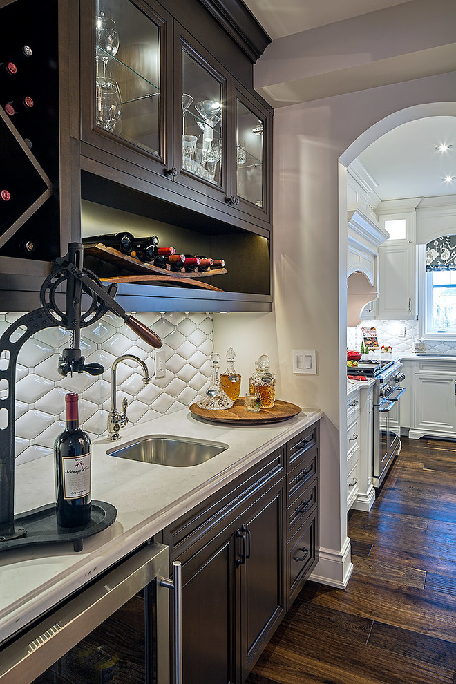 Mid-sized transitional l-shaped enclosed kitchen photo in Toronto with white cabinets, quartz countertops and an island