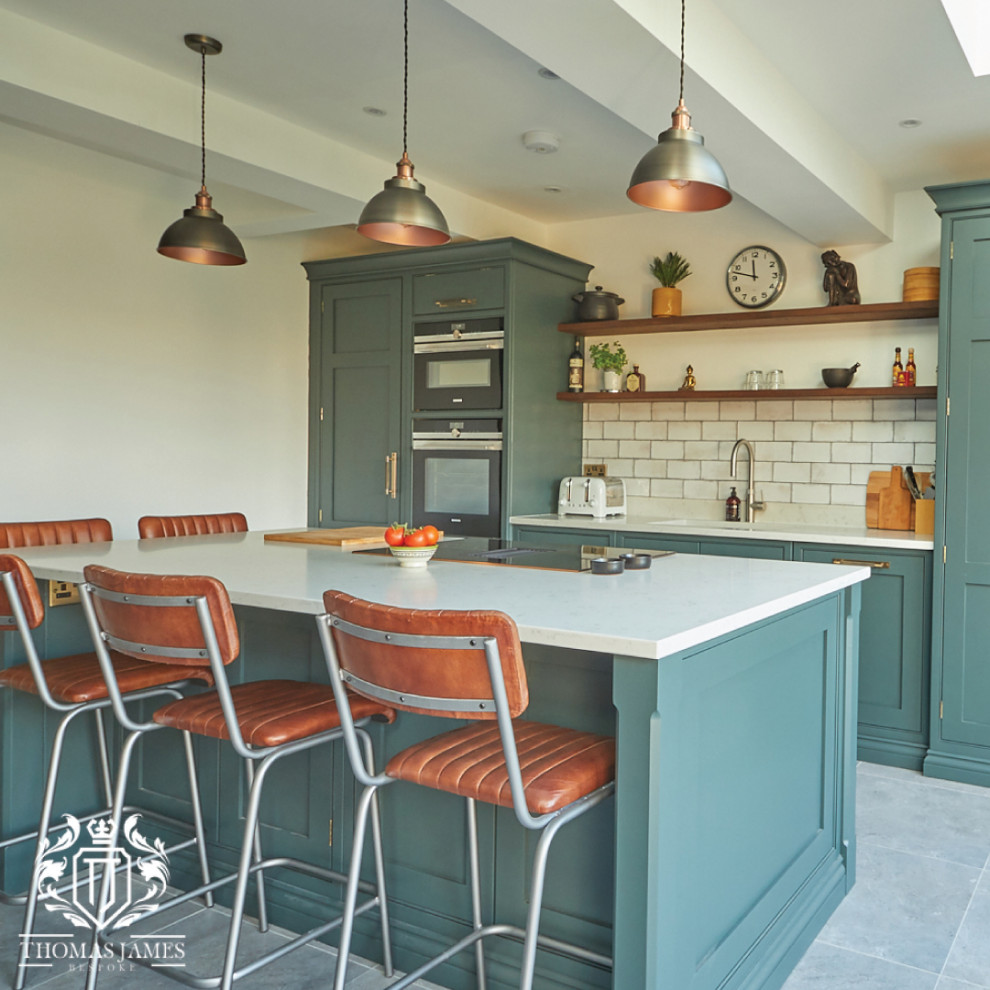 Photo of a large traditional eat-in kitchen in Manchester with shaker cabinets, green cabinets, quartzite benchtops, with island and white benchtop.