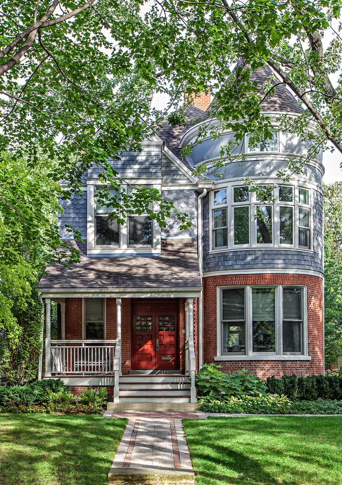 Inspiration for a traditional three-storey blue exterior in Chicago with mixed siding and a gable roof.