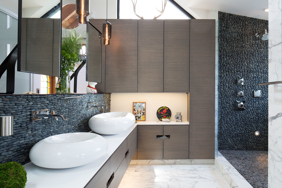 This is an example of a contemporary bathroom in San Francisco with a vessel sink, flat-panel cabinets, grey cabinets, an open shower, gray tile, pebble tile, white walls and an open shower.