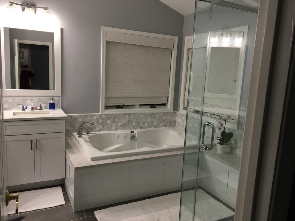 Inspiration for a large transitional master gray tile, white tile and porcelain tile porcelain tile and gray floor drop-in bathtub remodel in Baltimore with shaker cabinets, white cabinets, purple walls, an undermount sink, quartz countertops, a hinged shower door and white countertops