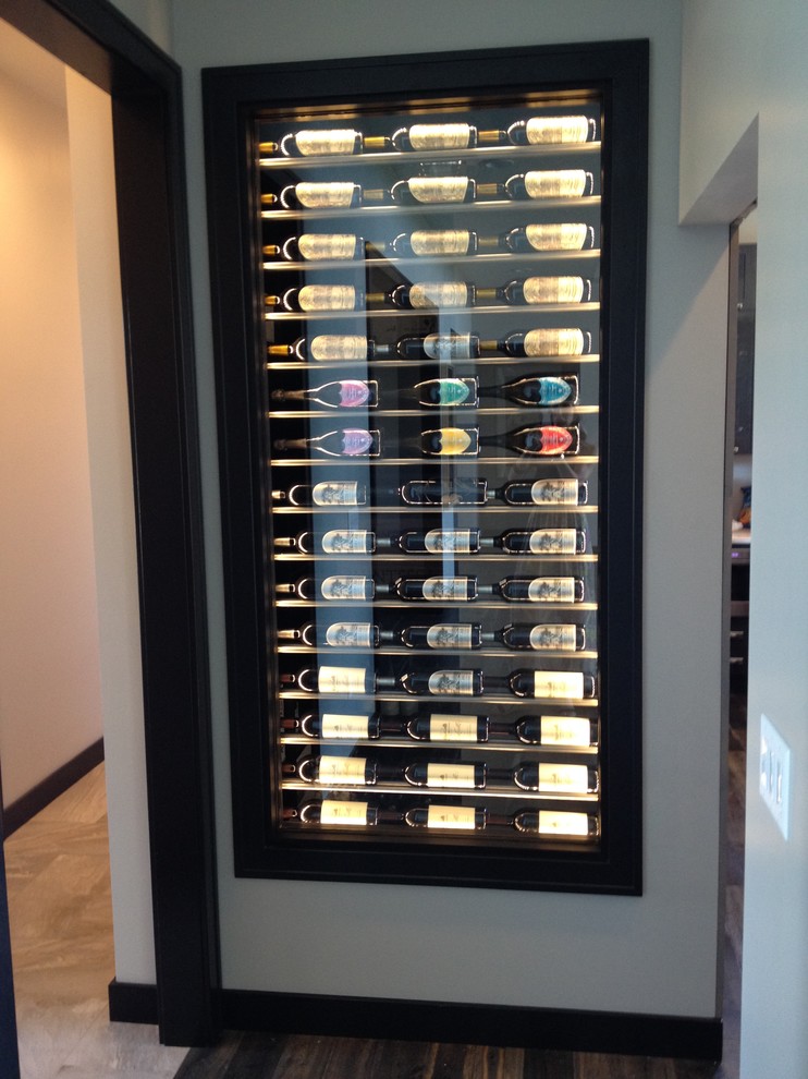 Photo of a small contemporary wine cellar in Cedar Rapids with display racks.