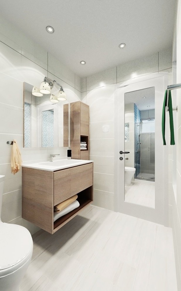 Design ideas for a small modern 3/4 bathroom in Austin with furniture-like cabinets, light wood cabinets, a curbless shower, a bidet, multi-coloured tile, mosaic tile, white walls, light hardwood floors, a drop-in sink, laminate benchtops, brown floor, a hinged shower door and white benchtops.