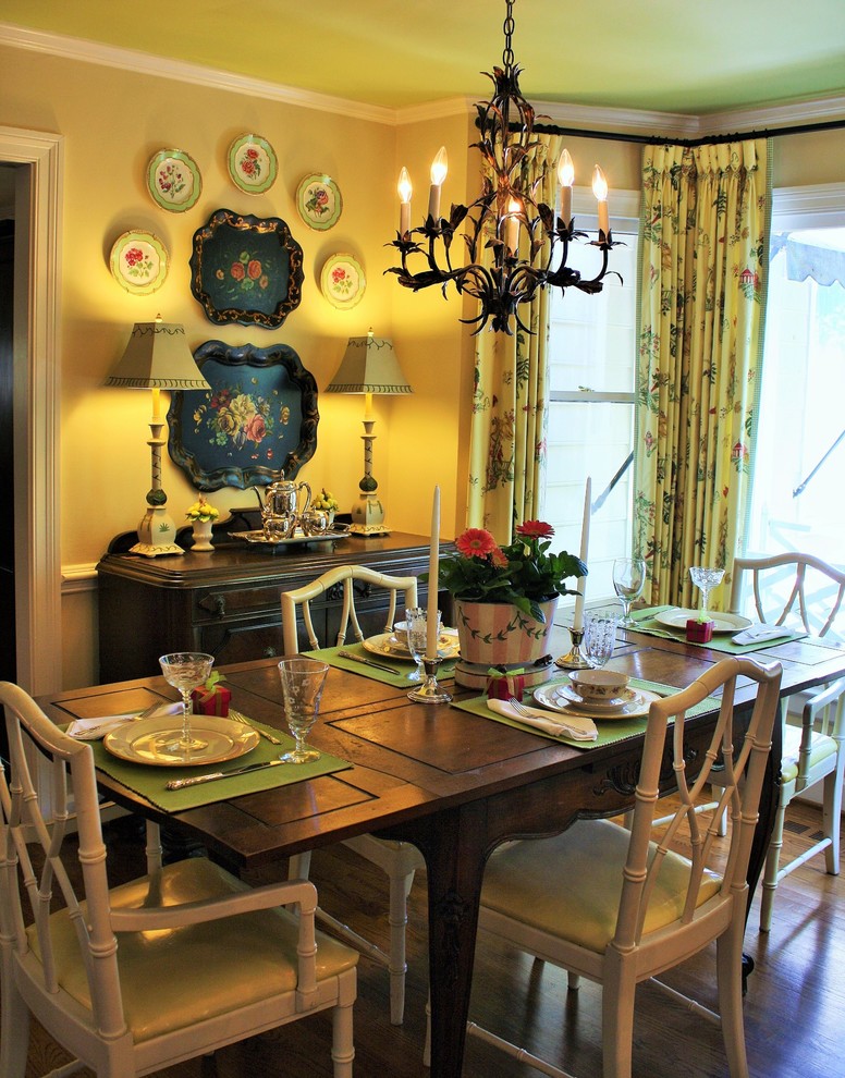 Mid-sized traditional separate dining room in Raleigh with yellow walls, dark hardwood floors and no fireplace.