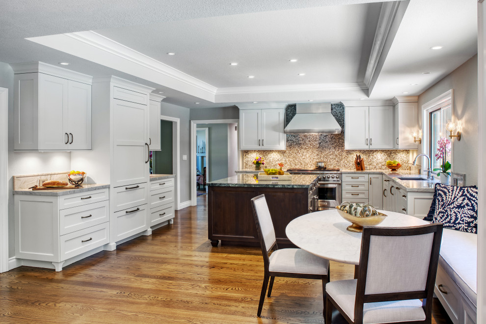 Design ideas for a large transitional u-shaped open plan kitchen in San Francisco with an undermount sink, recessed-panel cabinets, white cabinets, quartzite benchtops, multi-coloured splashback, mosaic tile splashback, panelled appliances, medium hardwood floors, with island, brown floor, white benchtop and coffered.