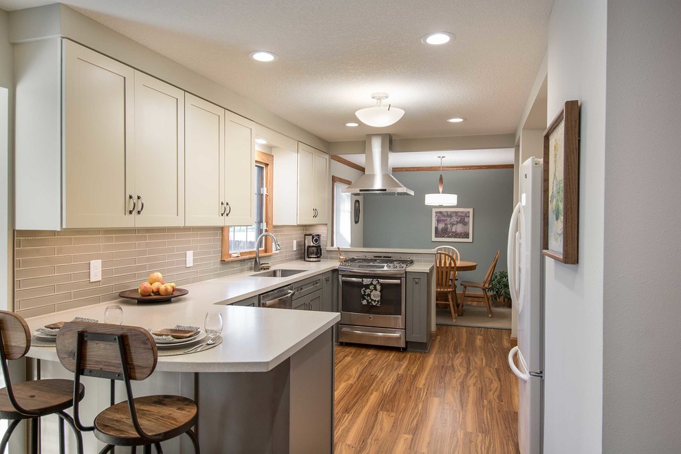 Inspiration for a small transitional galley vinyl floor eat-in kitchen remodel with recessed-panel cabinets, white cabinets, gray backsplash and stainless steel appliances