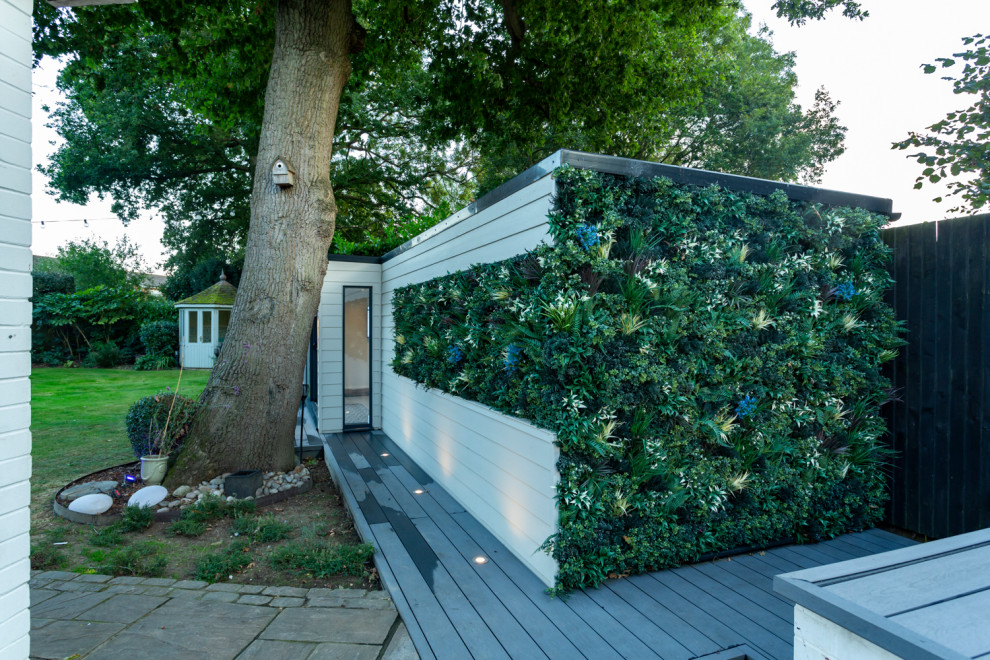 Design ideas for a mid-sized modern backyard garden in Sussex.