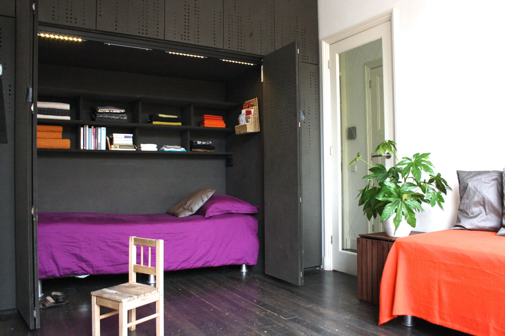 Inspiration for a contemporary gender-neutral dark wood floor kids' room remodel in Amsterdam with multicolored walls