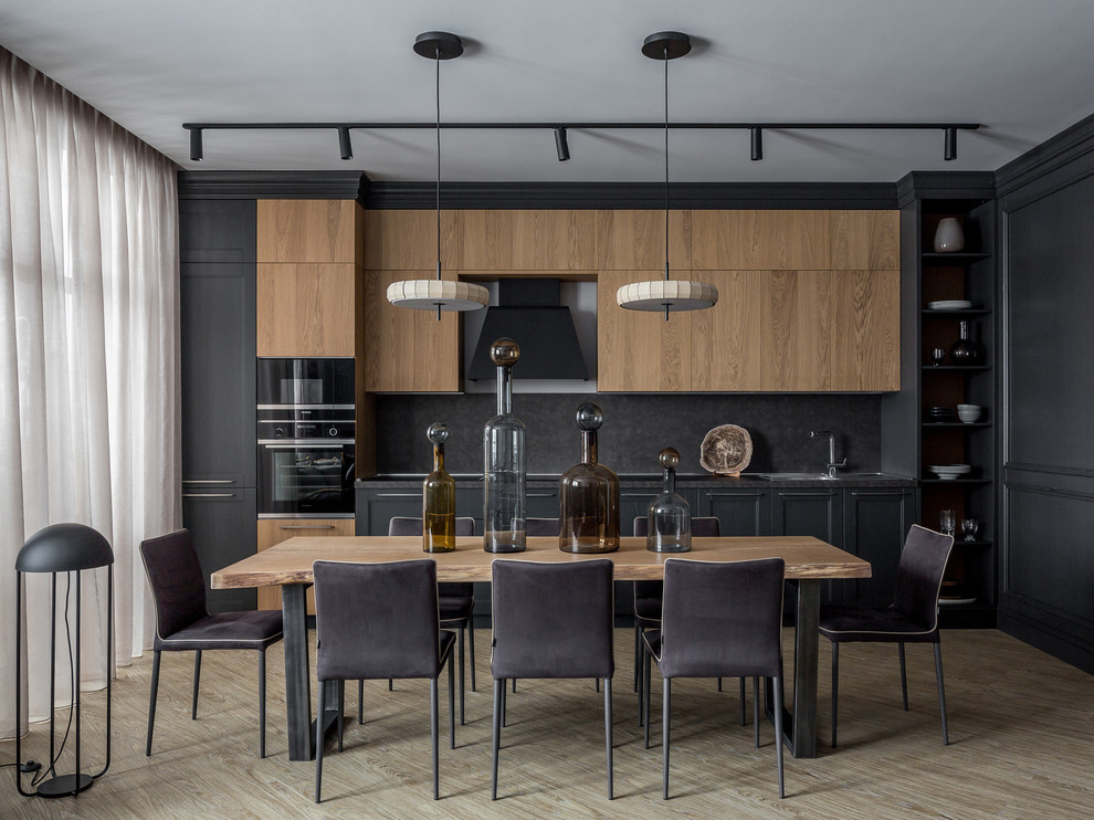 Mid-sized contemporary single-wall open plan kitchen in Other with a single-bowl sink, recessed-panel cabinets, grey cabinets, laminate benchtops, grey splashback, stainless steel appliances, vinyl floors, no island, grey benchtop and beige floor.