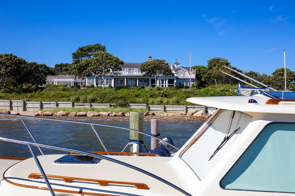 Example of a mid-sized beach style two-story wood gable roof design in Boston
