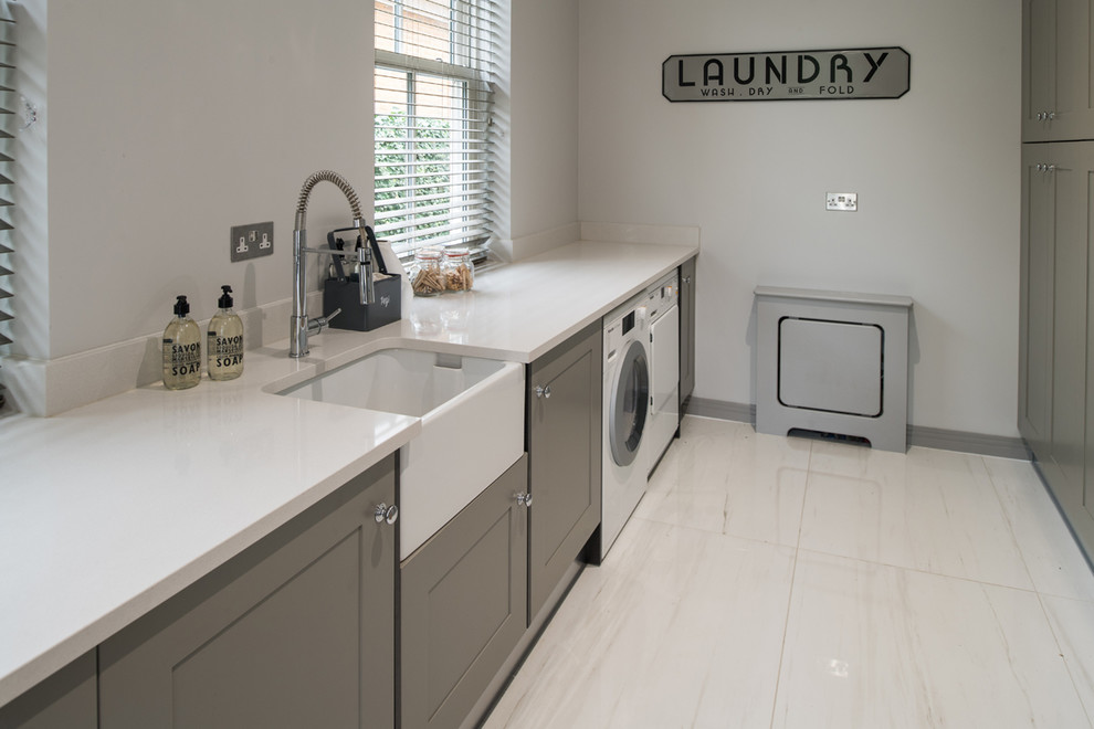 Photo of a contemporary laundry room in London with porcelain floors and beige floor.