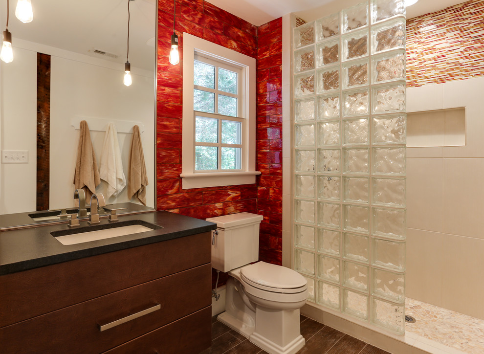Photo of a small country bathroom in Raleigh with an undermount sink, flat-panel cabinets, medium wood cabinets, granite benchtops, an open shower, a two-piece toilet, glass tile, red walls, ceramic floors, red tile, brown floor and an open shower.