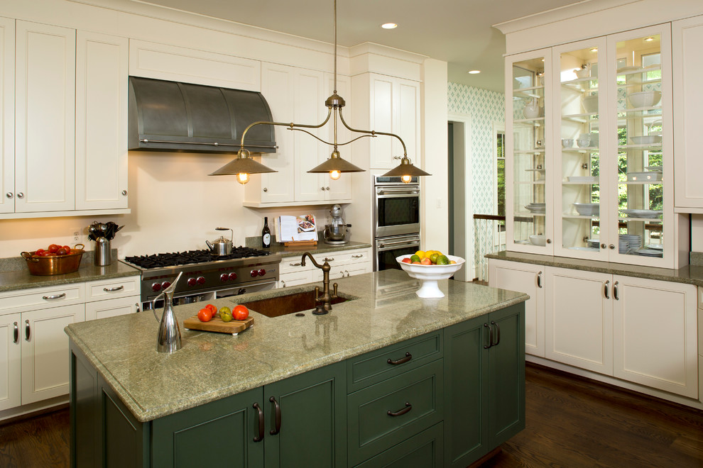 This is an example of a traditional kitchen in DC Metro with an undermount sink, beaded inset cabinets, green cabinets, granite benchtops and stainless steel appliances.