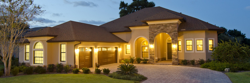 Design ideas for a transitional one-storey beige exterior in Orlando with mixed siding.