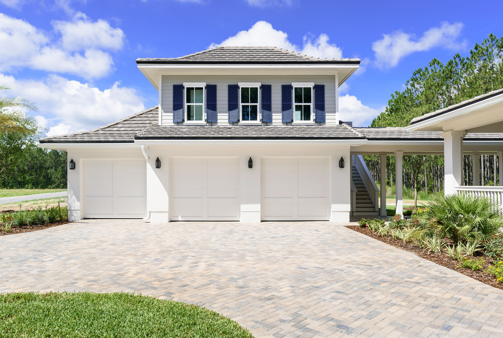 Design ideas for a large beach style detached three-car garage in Jacksonville.