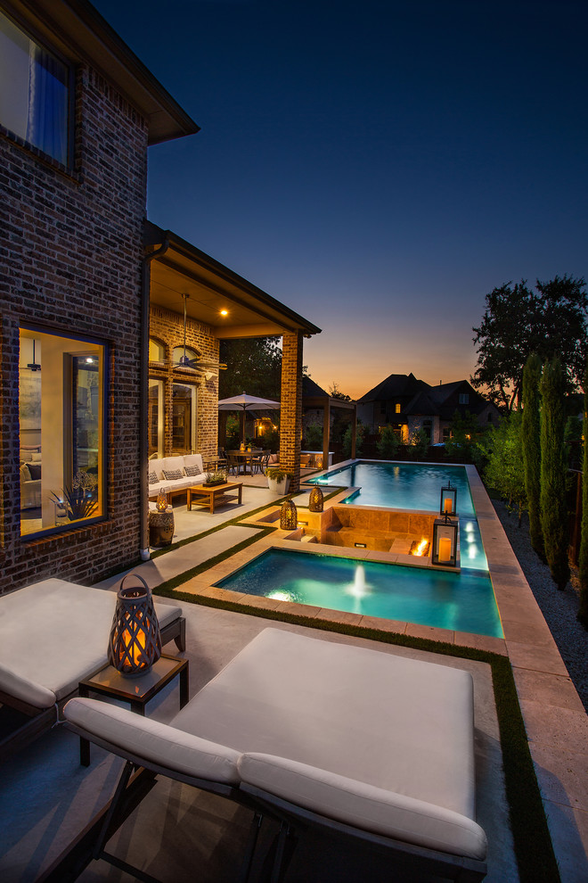 Inspiration for a mid-sized traditional backyard rectangular lap pool in Dallas with a hot tub and concrete slab.