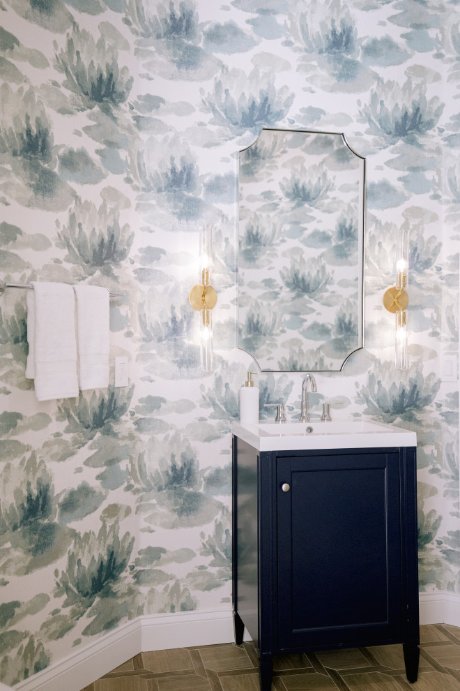 Bathroom - mid-sized tropical ceramic tile, brown floor, single-sink and wallpaper bathroom idea in Orlando with beaded inset cabinets, blue cabinets, multicolored walls, a drop-in sink, quartz countertops, white countertops and a freestanding vanity