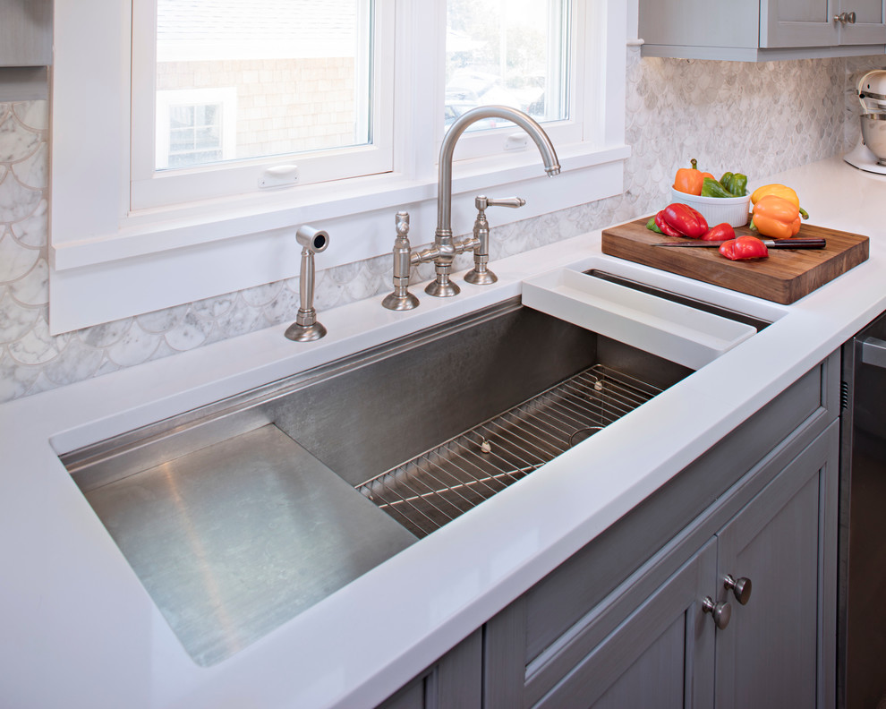 Kitchen - large transitional kitchen idea with recessed-panel cabinets, gray cabinets, quartz countertops, gray backsplash, stainless steel appliances and an island