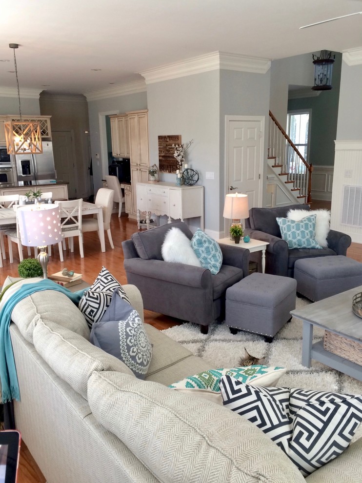 Inspiration for a mid-sized modern open concept medium tone wood floor and brown floor living room remodel in Charlotte with gray walls and a standard fireplace