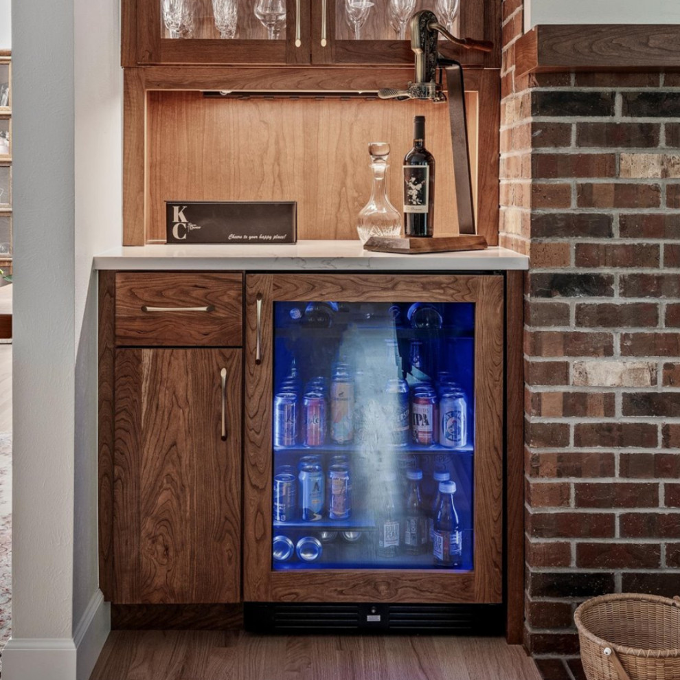 Large transitional l-shaped light wood floor and brown floor eat-in kitchen photo in Denver with an undermount sink, flat-panel cabinets, medium tone wood cabinets, quartzite countertops, white backsplash, ceramic backsplash, stainless steel appliances, an island and white countertops