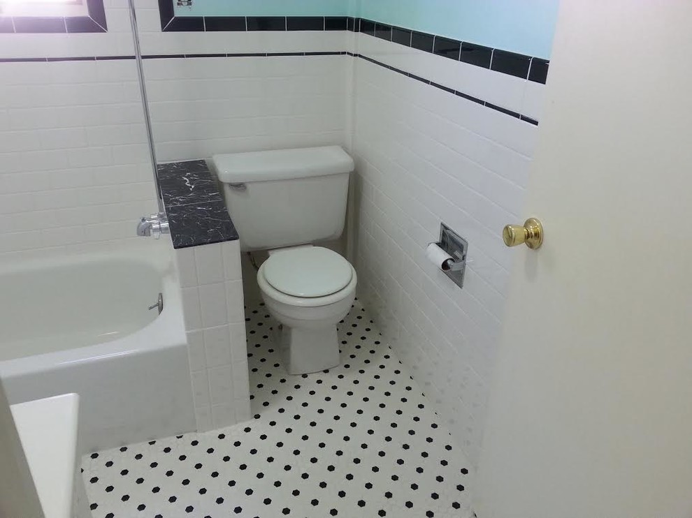 Inspiration for a mid-sized transitional master bathroom in Denver with an alcove tub, a shower/bathtub combo, blue walls, raised-panel cabinets, white cabinets, a two-piece toilet, white tile, porcelain tile, porcelain floors, an integrated sink, limestone benchtops, white floor and a shower curtain.