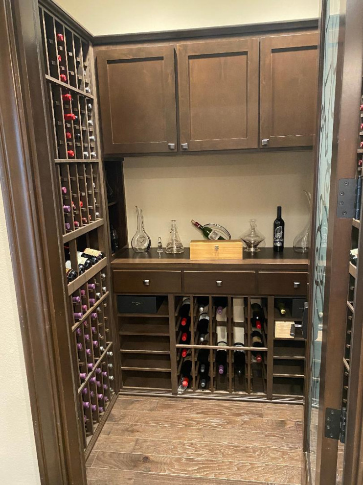 Mid-sized wine cellar in San Francisco with dark hardwood floors and storage racks.
