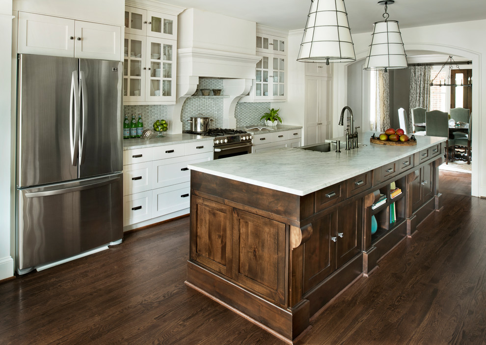 Inspiration for a traditional galley kitchen in Atlanta with with island, a farmhouse sink, shaker cabinets, white cabinets, stainless steel appliances, dark hardwood floors and brown floor.