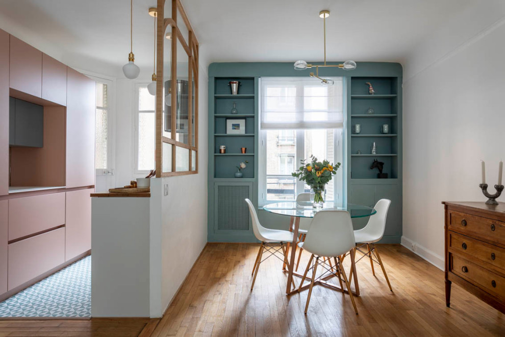 Inspiration for a small transitional galley eat-in kitchen in Paris with an undermount sink, pink cabinets, wood benchtops, mirror splashback, stainless steel appliances and light hardwood floors.