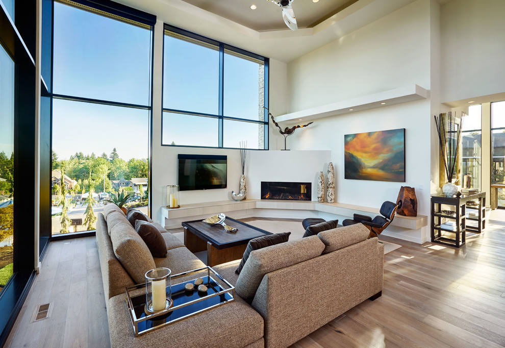Contemporary formal open concept living room in Portland with light hardwood floors, a ribbon fireplace and a wall-mounted tv.