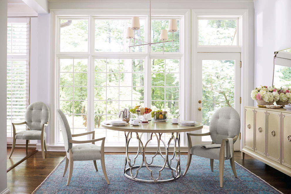 Inspiration for a mid-sized traditional separate dining room in Miami with white walls, medium hardwood floors, no fireplace and brown floor.