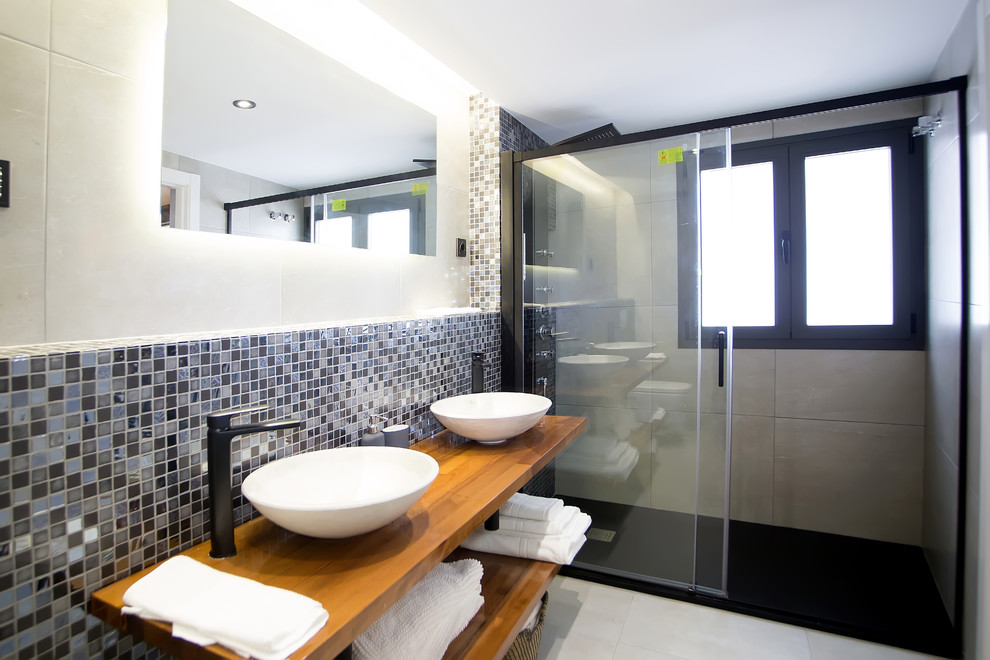 Mid-sized modern master bathroom in Madrid with white tile, ceramic tile, white walls, porcelain floors, a drop-in sink, wood benchtops, grey floor, a sliding shower screen and brown benchtops.