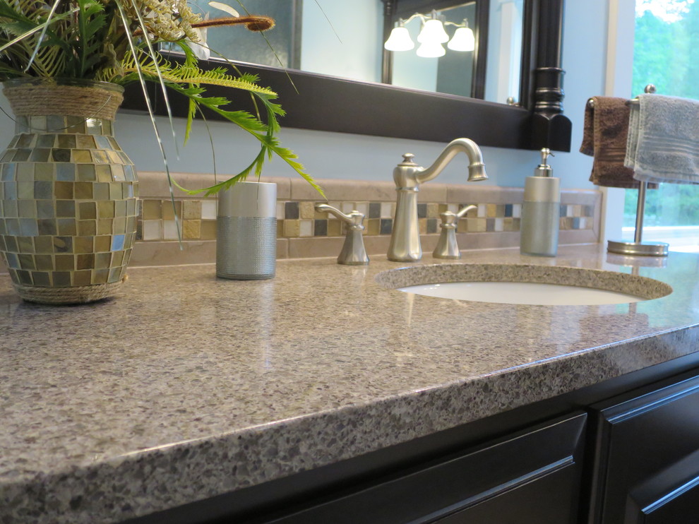 Home design - large transitional master beige tile and porcelain tile home design idea with an undermount sink, raised-panel cabinets, dark wood cabinets, quartz countertops and blue walls
