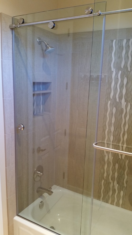 Transitional beige tile and ceramic tile alcove bathtub photo in Phoenix with beige walls