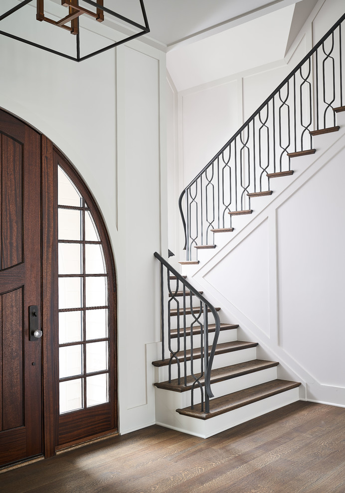 Contemporary wood staircase in Charlotte with painted wood risers and metal railing.