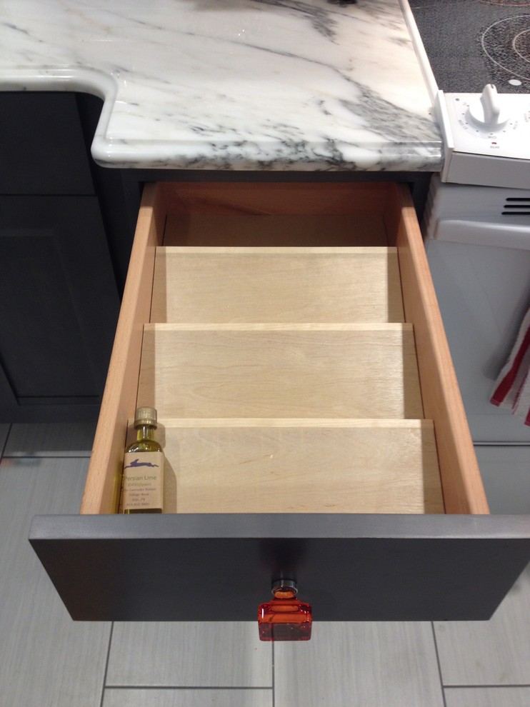 Inspiration for a large transitional u-shaped porcelain tile eat-in kitchen remodel with a farmhouse sink, flat-panel cabinets, gray cabinets, marble countertops, white backsplash, ceramic backsplash, white appliances and no island
