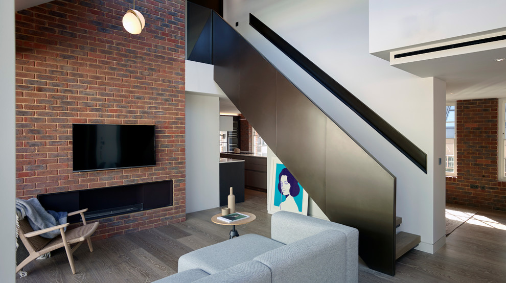 This is an example of a mid-sized contemporary wood straight staircase in London with metal risers.